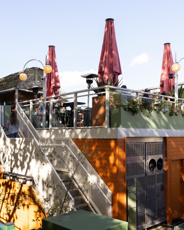 The Arbory Afloat floating cocktail bar, with a white metal staircase running up to the top deck