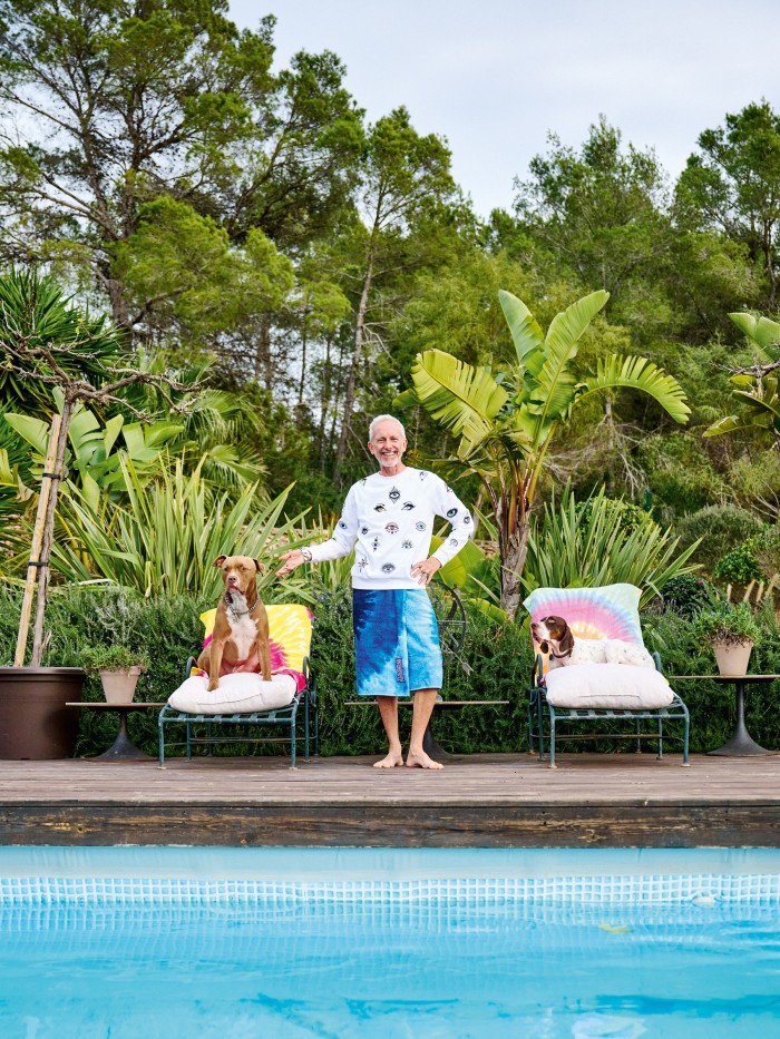 Cox by the pool with his dogs, Titus and Pompeii