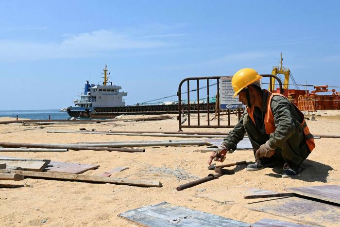 A labourer works at a construction site that is part of a Chinese-funded project for Port City in Colombo, Sri Lanka, under the Belt and Road Initiative