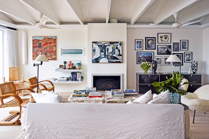 A Gervasoni sofa and Philip Arctander cloud chair sit below the couple’s contemporary art collection, including a Kirsty Budge above the fireplace