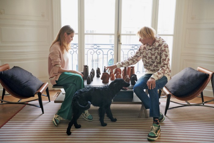 Vodianova and her son Lucas Portman playing chess, wearing Fashion Baby trainers (available on Wanna Kicks)