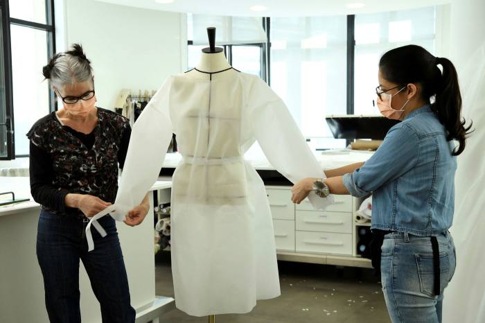 Seamstresses from Louis Vuitton put together a coat jacket for nurses
