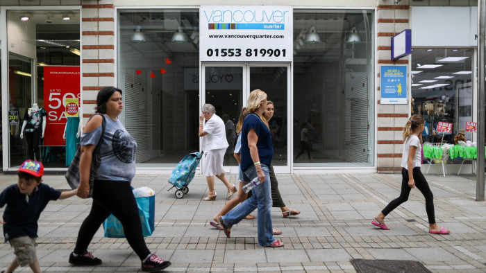 Pedestrians walk by a closed retail store in the Vancouver Quarter shopping district in King’s Lynn, UK, August 29 2017 