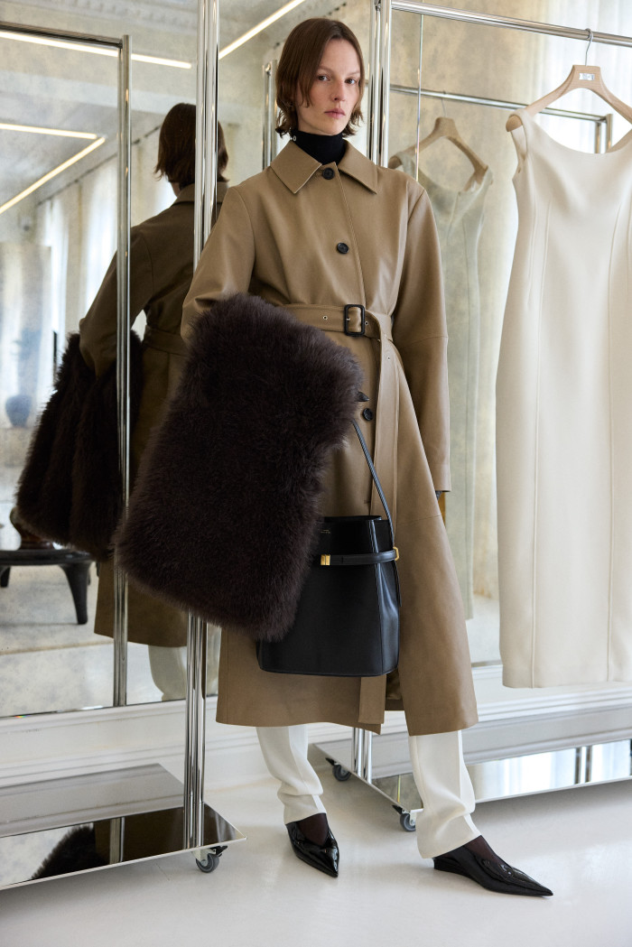 Toteme leather belted coat, £2,580, wool low-waist tailored trousers, £370, leather wedge-heel slingbacks, £480, faux-fur stole, £420, and leather belted bucket bag, £970