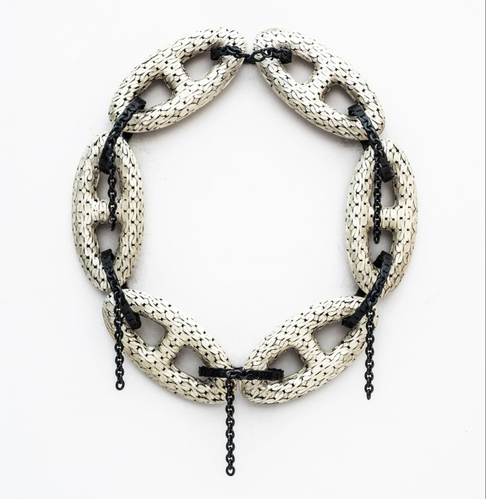 large metal chains created from smaller ones, some embellished with oversized hallmarks