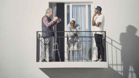 Three men having a discussion at a home terrace