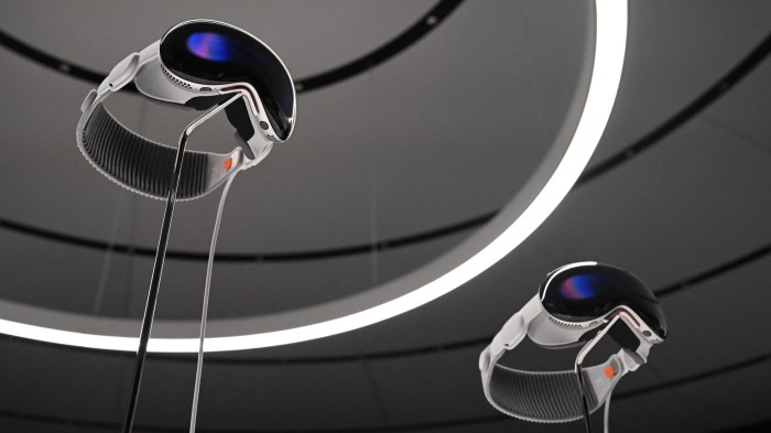 Apple’s Vision Pro virtual reality headsets on display on stands at the company’s campus in Cupertino, California