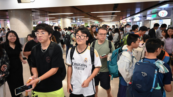 Tourists from mainland China enter Hong Kong through the Lo Wu border checkpoint