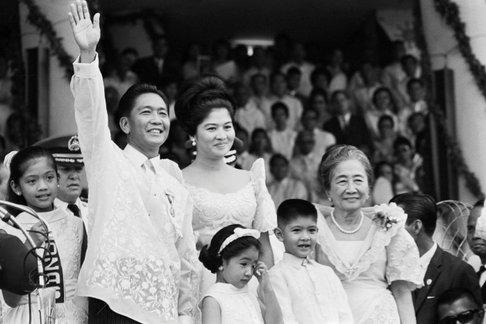 Accompanied by his family, Ferdinand Marcos waves to the crowd after his presidential  inauguration in 1965