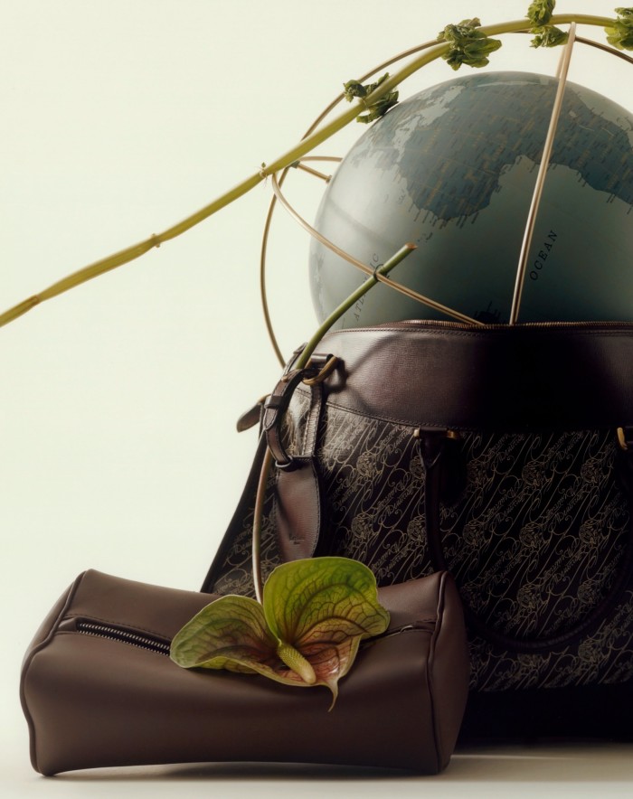 From left: Zegna leather mini bag, €890. Berluti leather and canvas Toile Marbeuf travel bag, £3,050. Hermès leather and gold-plated stainless-steel Odyssée 24 Earth globe, £22,240