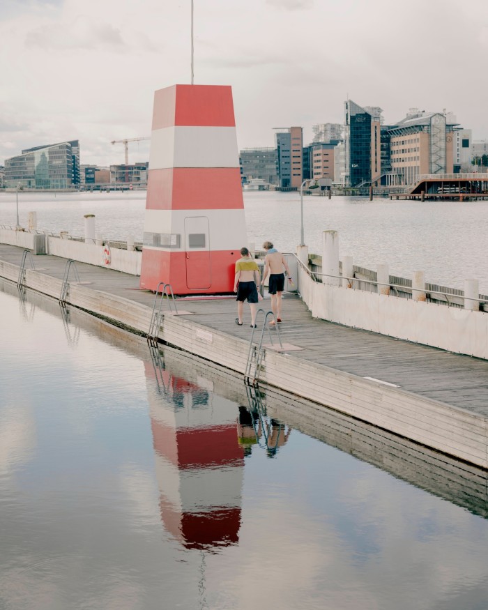 A red and white striped lifeguard tower at Islands Brygge baths