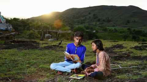 Kirma reads with her Uncle Rikesh Chauhan