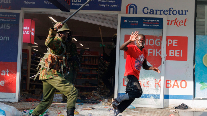 A protester tries to escape from a policeman during a demonstration in Nairobi