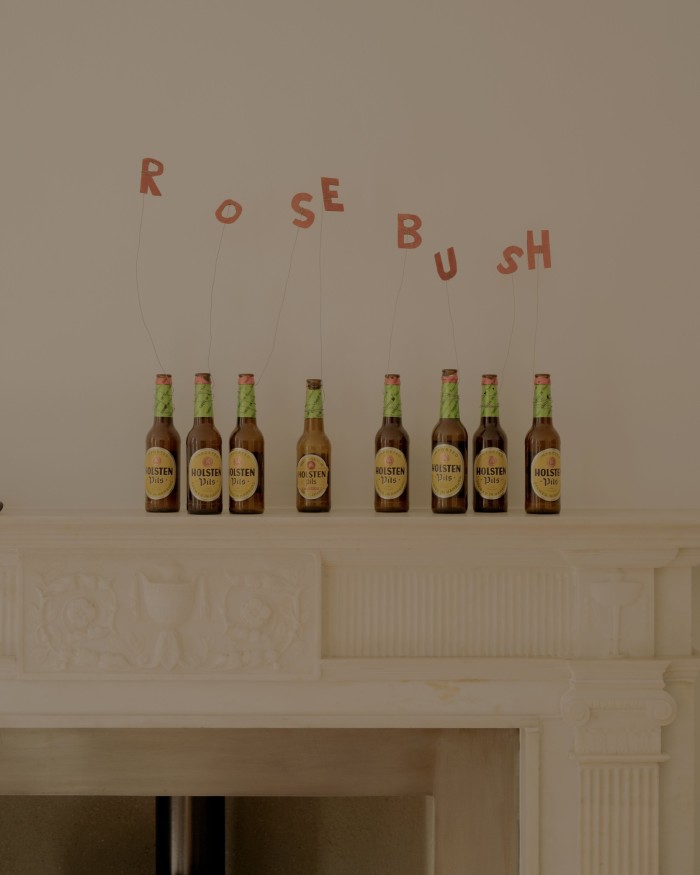 The letters in Rose Bush floating above beer bottles