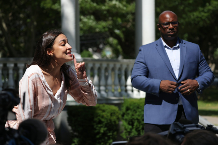 Alexandria Ocasio-Cortez speaking during the campaign while Jamaal Bowman looks on