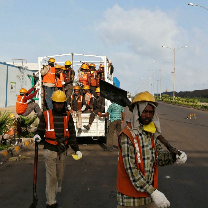 Workers arrive at Mundra Port Coal Terminal in the western Indian state of Gujarat