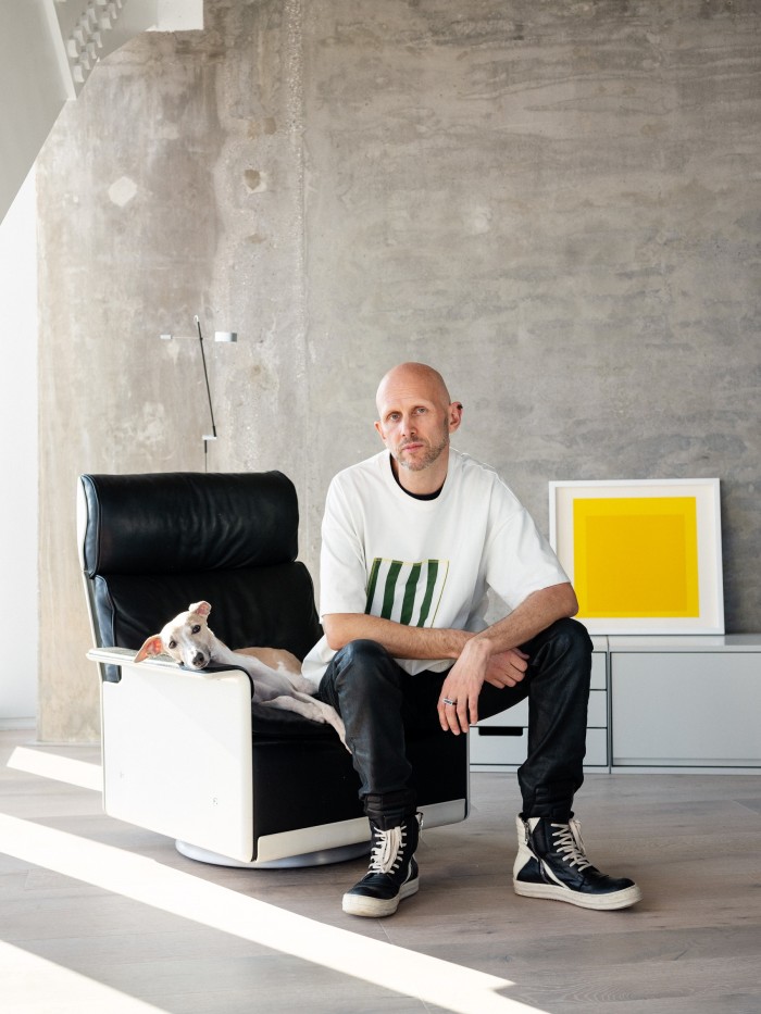 Wayne McGregor in his library, sitting on his favourite Dieter Rams chair