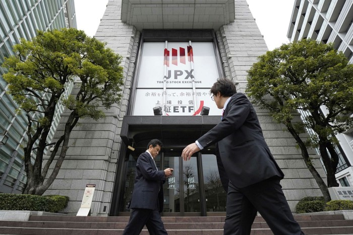 Pedestrians walk past the Tokyo Stock Exchange (TSE) building, operated by Japan Exchange Group Inc. (JPX), in Tokyo, Japan