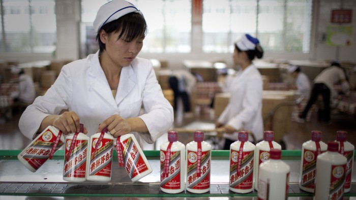 Workers package Kweichow Moutai baijiu liquor at a factory in Zunyi, Guizhou Province, China