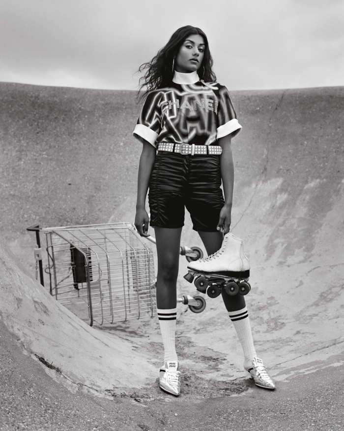 Chanel twill top, £5,355, and technical satin shorts, £1,810. Miu Miu technical fabric sneakers, £750. Vintage gold hoop earrings, POA, from Contemporary Wardrobe. Vintage vinyl belt, cotton sport socks and leather rollerskates (in hand), all POA, from Costume Studio