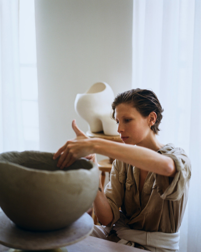 Kaminski at work in her studio. Behind her is Amen Philo Light Sculpture
