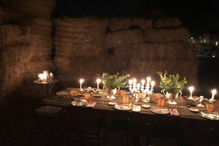 Candles and lanterns light a private dinner in the renovated barn