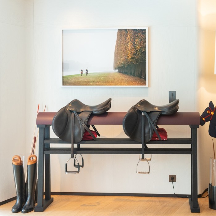 room with horse riding accessories and boots
