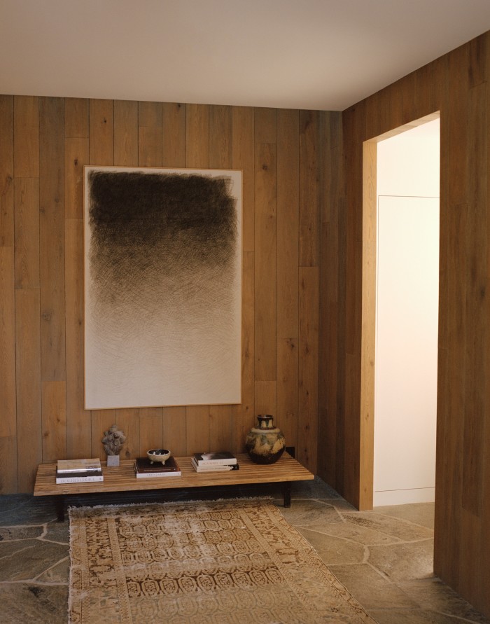The entrance, with artwork by A Armas and table by Charlotte Perriand