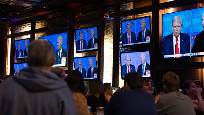 Guests watch a debate between President Joe Biden and presumptive Republican nominee former President Donald Trump