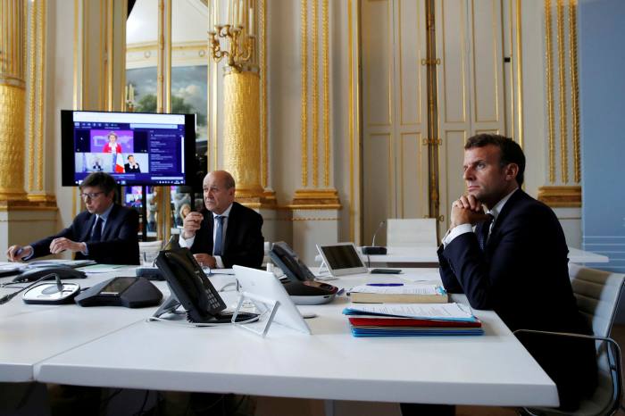 French president Emmanuel Macron takes part in a video conference on vaccination. France sparked furious protests when it seized millions of masks belonging to a Swedish healthcare company
