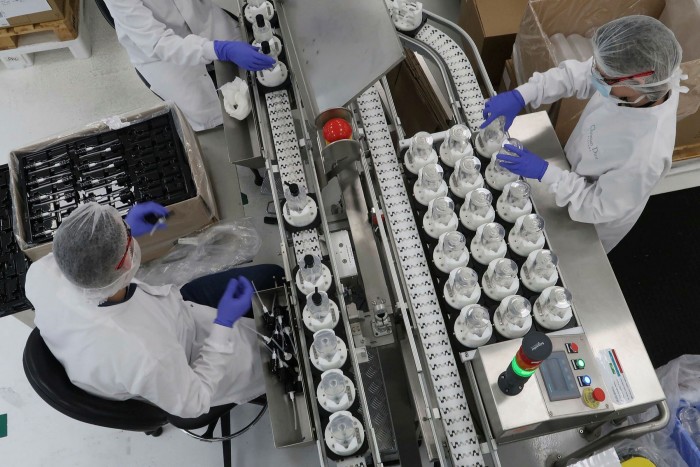 Workers at the Christian Dior factory make hand sanitisers for hospitals in Paris last March