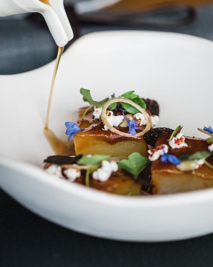 A bowl of miso-glazed eggplant, salt-baked kohlrabi and Vegemite consommé at Ten Minutes by Tractor’s restaurant