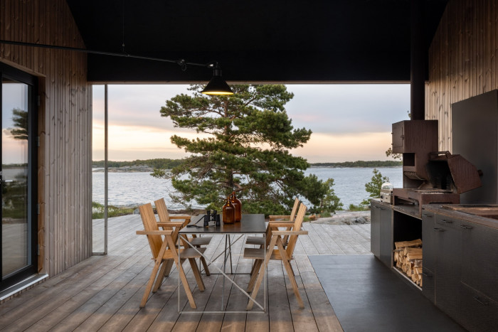Cabin terrace overlooking trees and lake