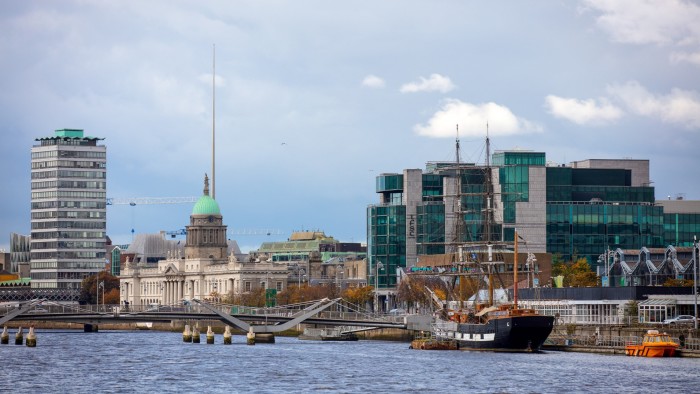 The river Liffey flows past Liberty Hall, Customs House and the IFSC in Dublin