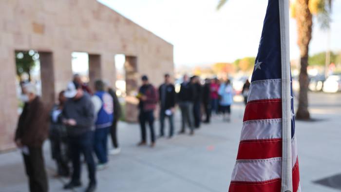 Voters wait in line to cast their ballots in Nevada