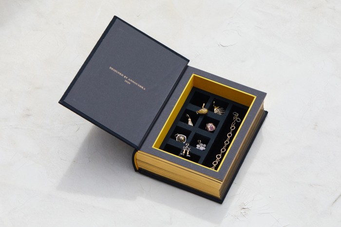 The suede-lined jewellery box has a compartment for each charm
