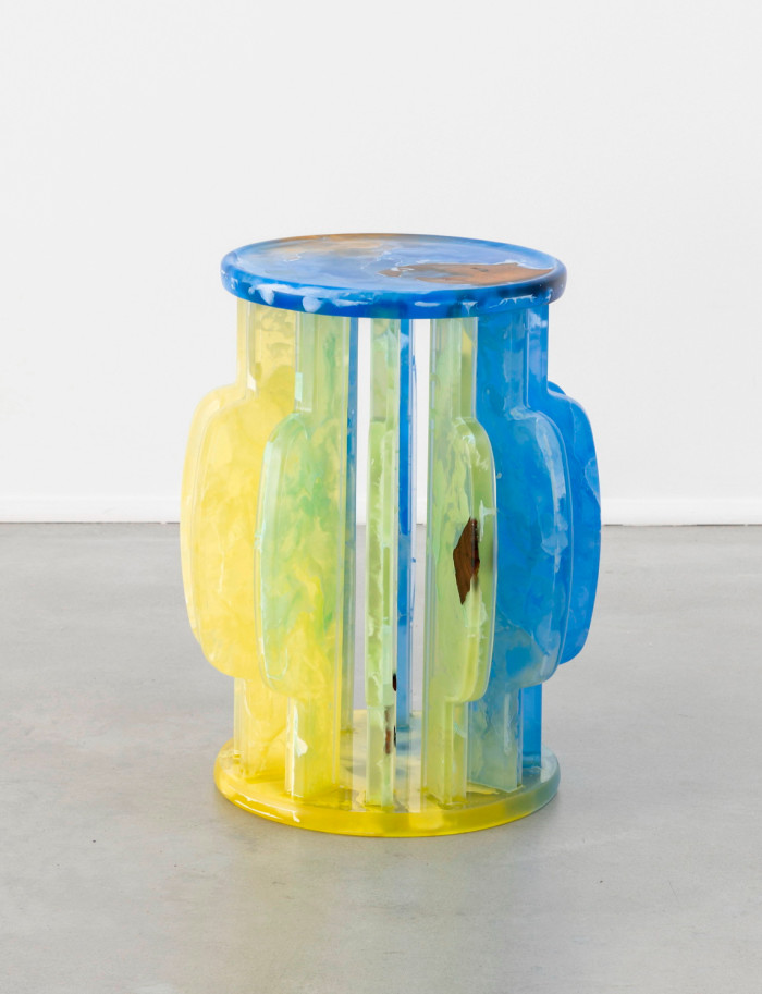 A small stool made of translucent plastic in yellow and blues