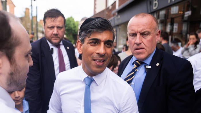Rishi Sunak surrounded by his security