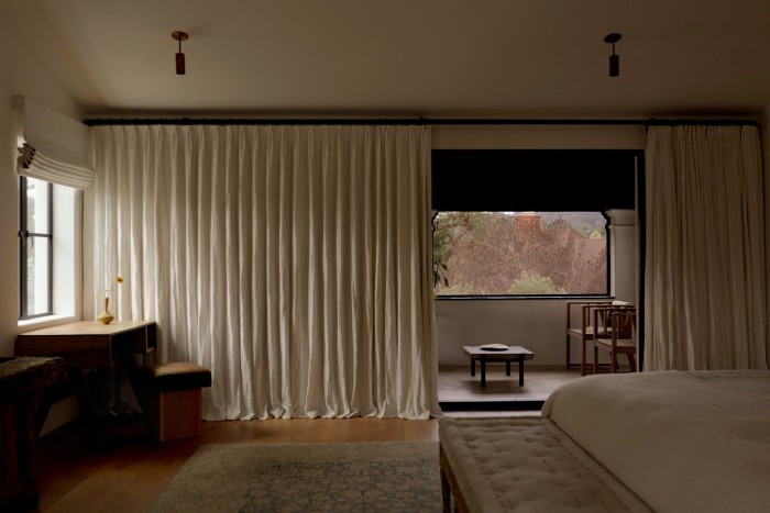 The bedroom features an early-18th-century Gustavian bench (at foot of bed) and, by the window, a 1960 teak student desk by Pierre Jeanneret and oak and cashmere stool by Green River Project
