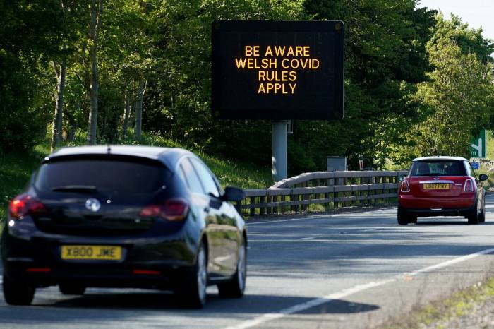 A sign advises motorists that lockdown rules in Wales are different to England