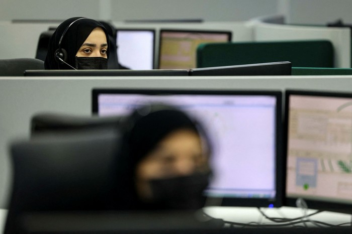 Mask-clad Saudi women working at a call centre in Mecca