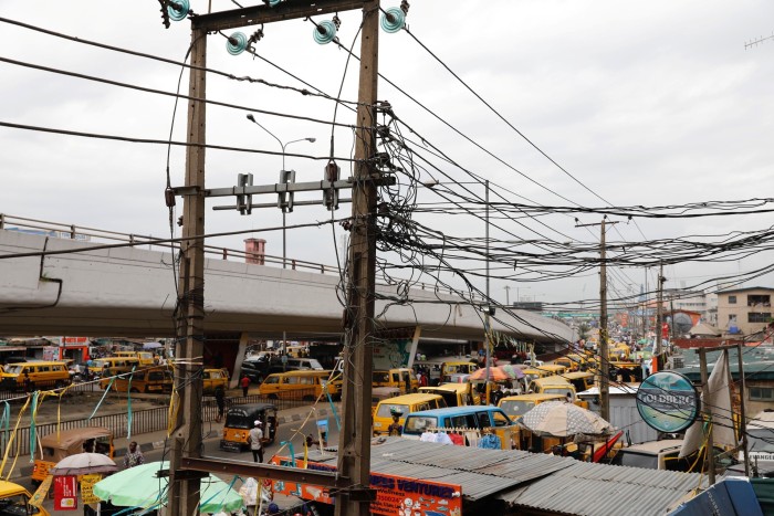 Multiple electric wires against a Lagos streetscape