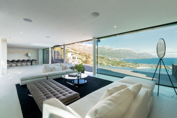A contemporary villa with a glass facade looking out to the ocean