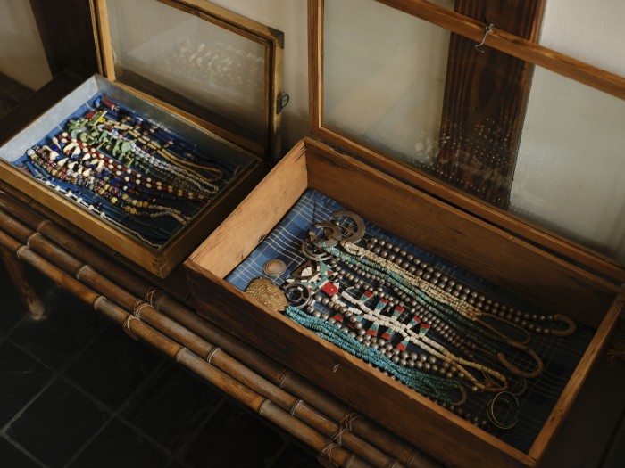 Two glass-topped boxes hold his collection of beaded necklaces