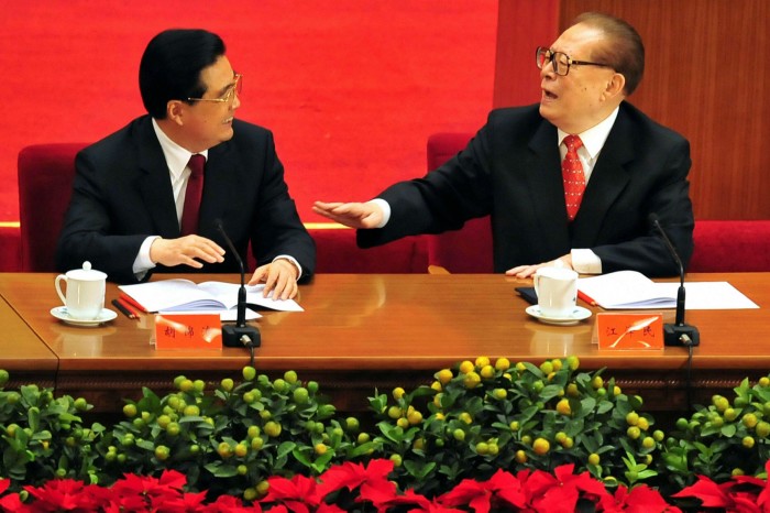 Then president Hu Jintao (L)  chats with his predecessor Jiang Zemin (R) as top Communist party leaders attend an event marking the 30th anniversary of economic reforms at the Great Hall of the People in Beijing in 2008