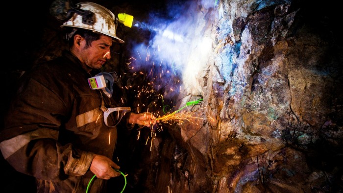 A miner places explosives inside the Kiara copper mine, south of Antofagasta, Chile
