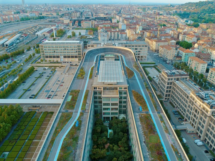 Aerial view of an oval racetrack on an office building with a view out over a city