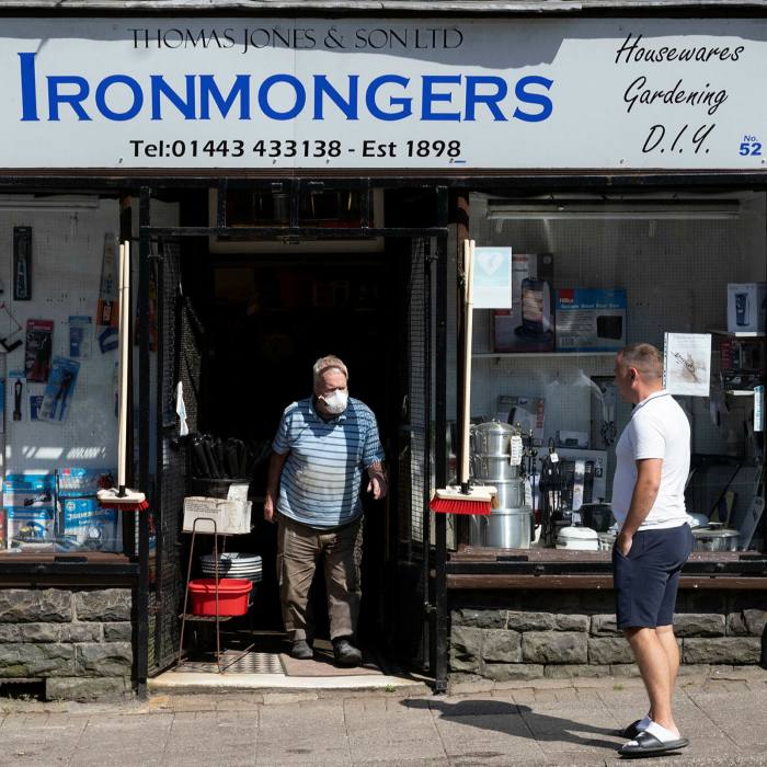 A customer leaves an Ironmongers wearing a face mask in Penygraig, Wales. Close to 6m small businesses employ more than 16m people in the UK, generating £2.2tn in turnover last year
