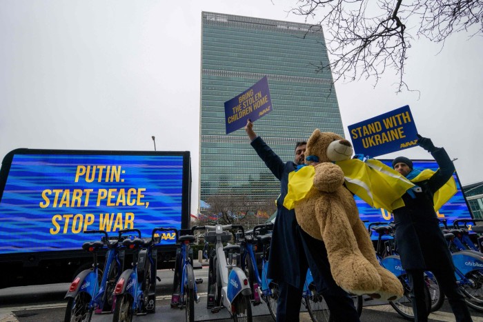 Protesters gather outside the UN headquarters 