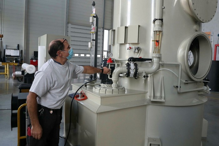 man operating machinery at the Aspach-le-Haut plant in Alsace, specializing in high-capacity electrolysers 